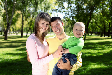 Young family with a child in summer park