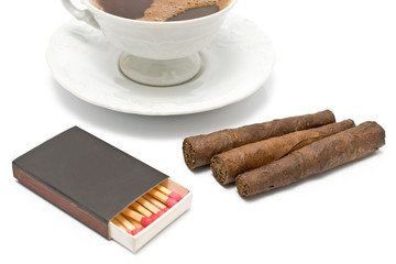 Cigars with matches and cup of coffee