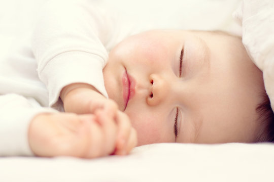 Close-up Portrait Of A Beautiful Sleeping Baby On White