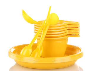 Bright yellow plastic tableware isolated on white