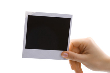 Photo paper in hand isolated on white