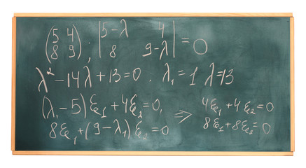 formulas written on green chalkboard