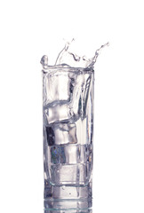 fresh water in glass with ice cubes isolated on white