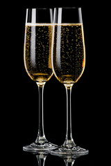 Two glasses of champagne on  black background