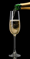 Champagne pouring into a glass on a black background