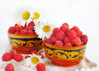 Still-life with a raspberry and camomiles