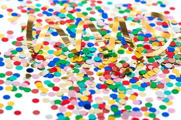 colorful confetti background with golden streamer