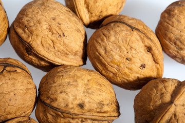 Close up of many scattered walnuts. Background.