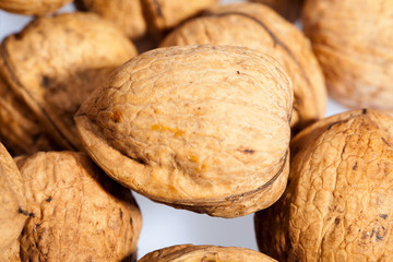 Close up of many scattered walnuts. Background.