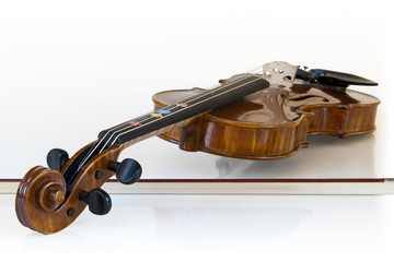 Plakat wooden classic violin lying on it's stick with white background