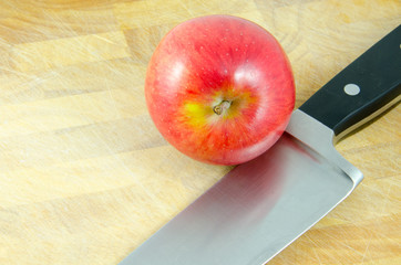 apple and knife on chopping board on white