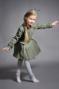 little girl dressed in the New Year on a gray background