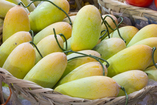 fake yellow mango in bamboo basket