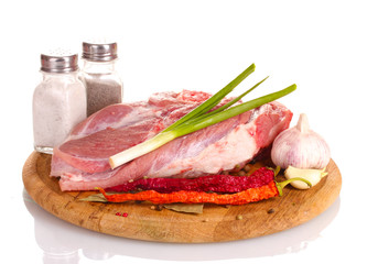 Raw meat and vegetables on a wooden board isolated on whitе