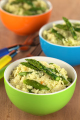 Green asparagus risotto in colorful bowls