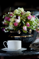 Coffee cup with flower and newspaper