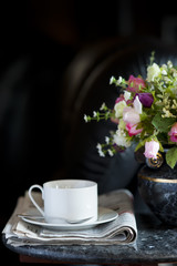 Coffee cup with flower and newspaper