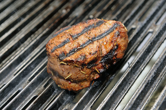 eef steak cooking on an open flame grill