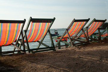 Deck chairs on Pattaya beach in Thailand.