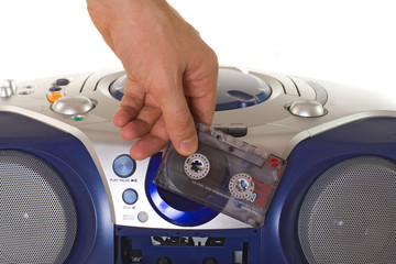 Inserting a cassette into tape recorder