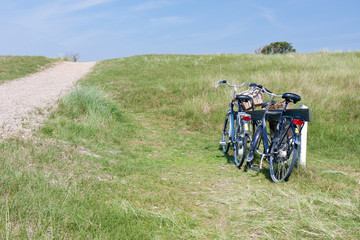 Two bicycles parked in the dunes in Netherlands.