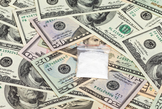 Package with drug over the  U.S. dollars background