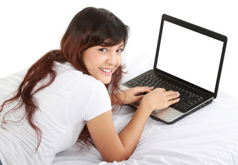 girl lying in bed with laptop