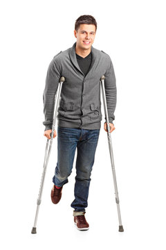 Full length portrait of an injured young man on crutches