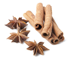 Cinnamon sticks and anise stars close-up on white background