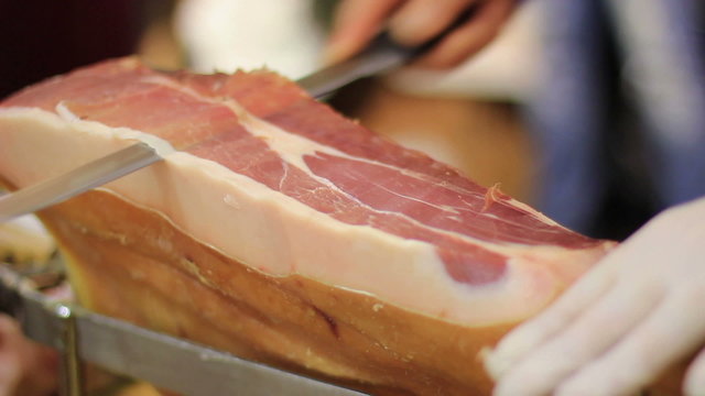 Expert caterer slicing ham