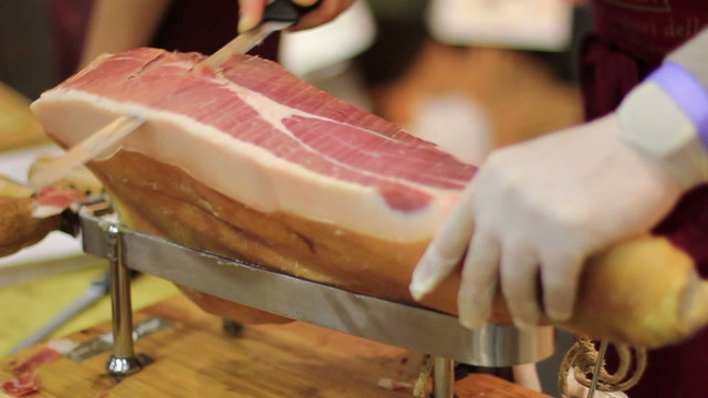 Expert caterer slicing ham
