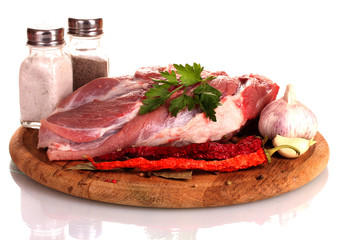 Raw meat and vegetables on a wooden board isolated on whitе