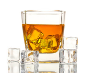 Glass of scotch whiskey and ice isolated on white