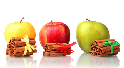 Cinnamon sticks and apples isolated on white