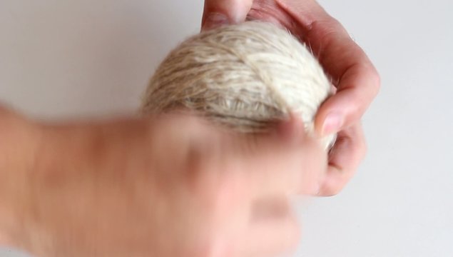 Winding thread on a ball of yarn by hand. HD H.264