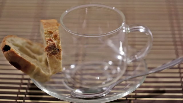 Flowing tea in a cup with a saucer, toasts,