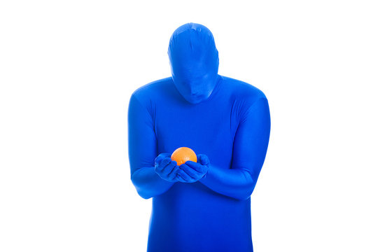 Faceless Man In Blue Body Suit Staring At An Orange