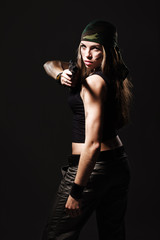 Fototapeta premium Sexy woman with Gun on dark