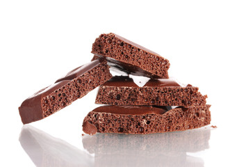 Slices of milk chocolate bar isolated on white
