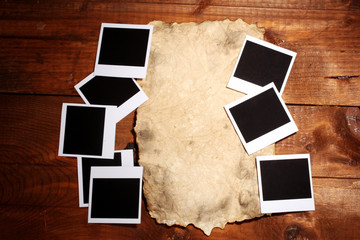 Photo papers with old paper on wooden background