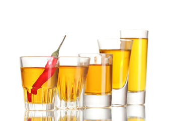 glasses of pepper vodka and red chili pepper isolated on white