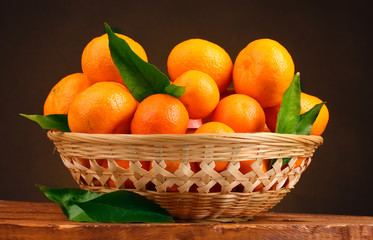 tangerines with leaves in a beautiful basket