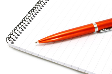 Notepad with orange ball pen on a white background