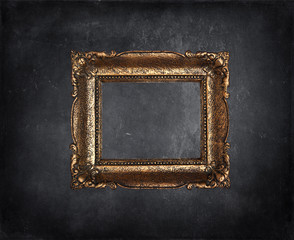 Antique picture frame on black grunge wall
