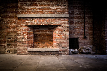 Background of brick wall and fireplace in vacant setting - obrazy, fototapety, plakaty