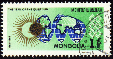 Post stamp with map Globe and symbol of the Sun