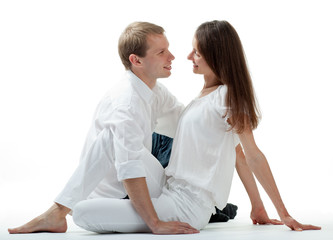 Young smiling flirting couple sitting on the floor