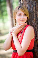 Portrait of girl in red near the tree