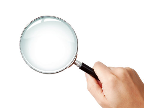 Man's hand holding classic styled magnifying glass