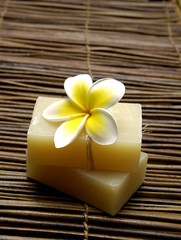 Fototapeta na wymiar natural handmade soap with frangipani on mat